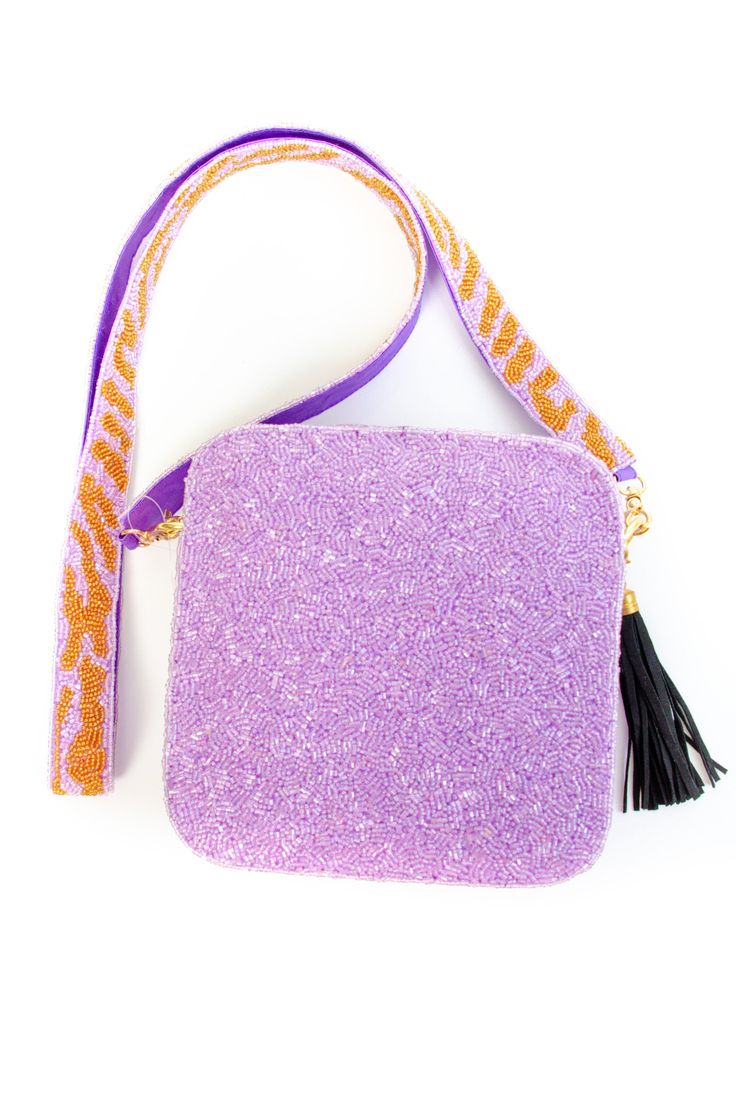 This Tiger Face Sequin bag is sure to turn some heads as you strut by! This custom hand-beaded bag is one of our favorites. Use it as an everyday bag or style for a Game Day purse! Make sure to check out the interchangeable straps! Zipper closure on top. The strap length is 48" long and the bag is 6x6. All hand-beaded products are available for pre-order. Items could take 4+ weeks to ship depending on available stock. All beaded accessories are hand-made, so please note that the stock informatio Everyday Beaded Pouch Bag, Purple Beaded Bag For Everyday Use, Beaded Purple Bag For Everyday Use, Purple Beaded Shoulder Bag For Everyday Use, Purple Beaded Bags For Everyday Use, Square Beaded Bag For Everyday Use, Purple Beaded Evening Bag, Chic Beaded Travel Bags, Everyday Beaded Crossbody Bag