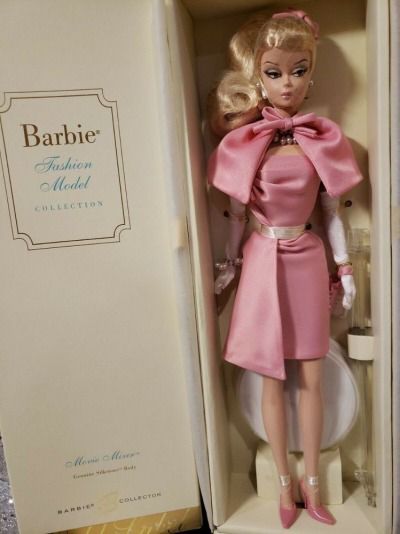 a barbie doll in a pink dress and white gloves