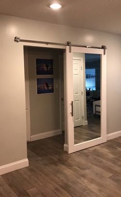 an empty living room with sliding glass doors and hard wood flooring in front of the door