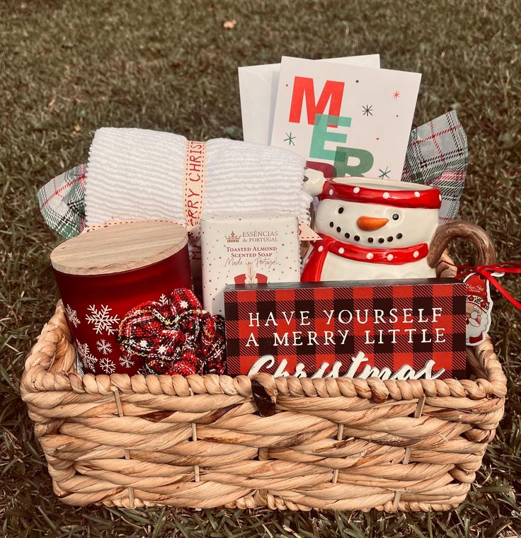 a basket filled with christmas items on the grass