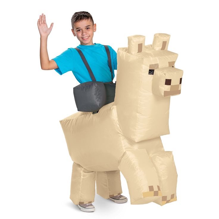 a boy in a blue shirt is standing next to an inflatable horse