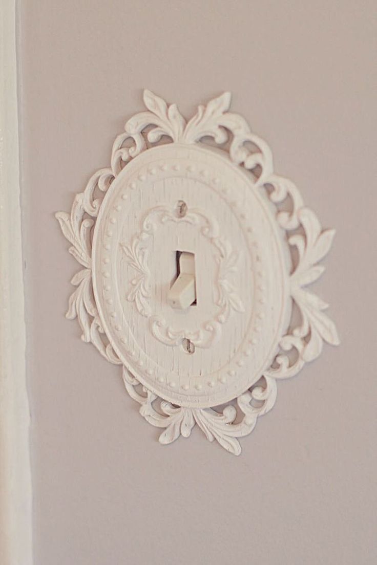 a white light switch sitting on top of a wall