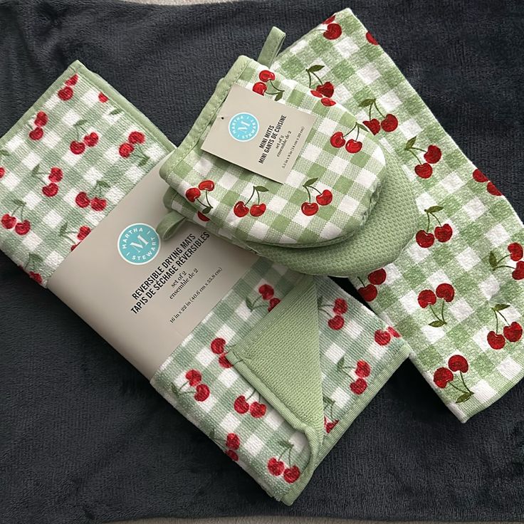 three folded cloths with cherries on them