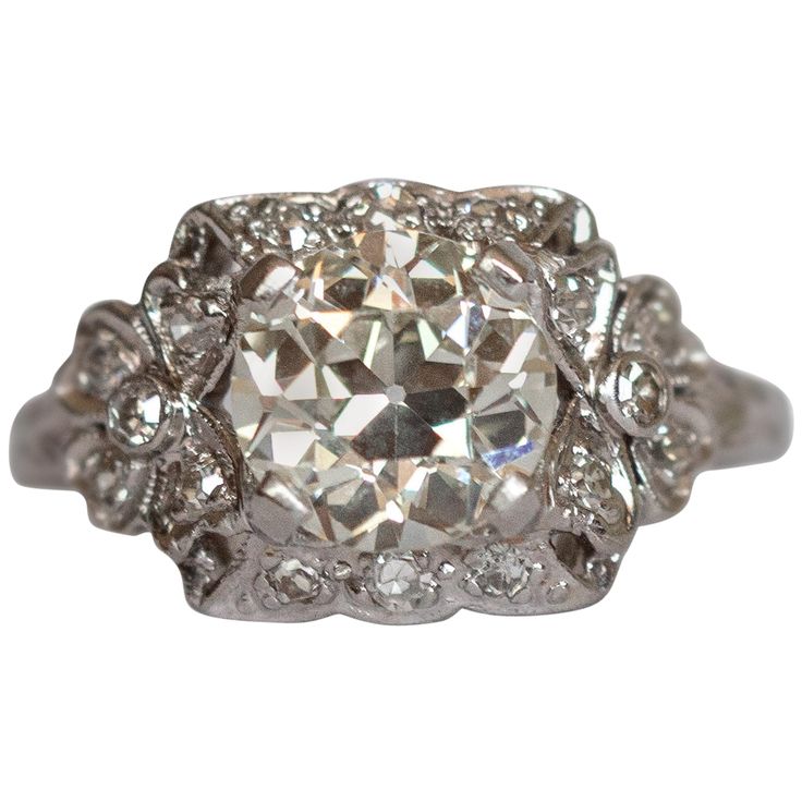 Ring Size: 6 Metal Type: Platinum [Hallmarked, and Tested] Weight: 4 grams Center Diamond Details: GIA REPORT #:2213082074 Weight: 1.68 carat Cut: Old European Brilliant Color: M Clarity: SI1 Side Diamond Details: Weight: .25 carat, total weight Cut: Antique Single Cut Color: G Clarity: VS Finger to Top of Stone Measurement: 5.5 mm Condition: Excellent Antique Cushion Cut Single Diamond Rings, Antique Cushion Cut Ring With Single Cut Diamonds, Antique Cushion Cut Rings With Single Cut Diamonds, Collectible Platinum Diamond Ring In Diamond White, Collectible Diamond White Platinum Diamond Ring, Platinum Collectible Diamond Ring, Platinum Diamond Ring With Diamond Cut For Collectibles, Collectible Platinum Diamond Ring With Brilliant Cut, Collectible Platinum Rings With Brilliant Cut