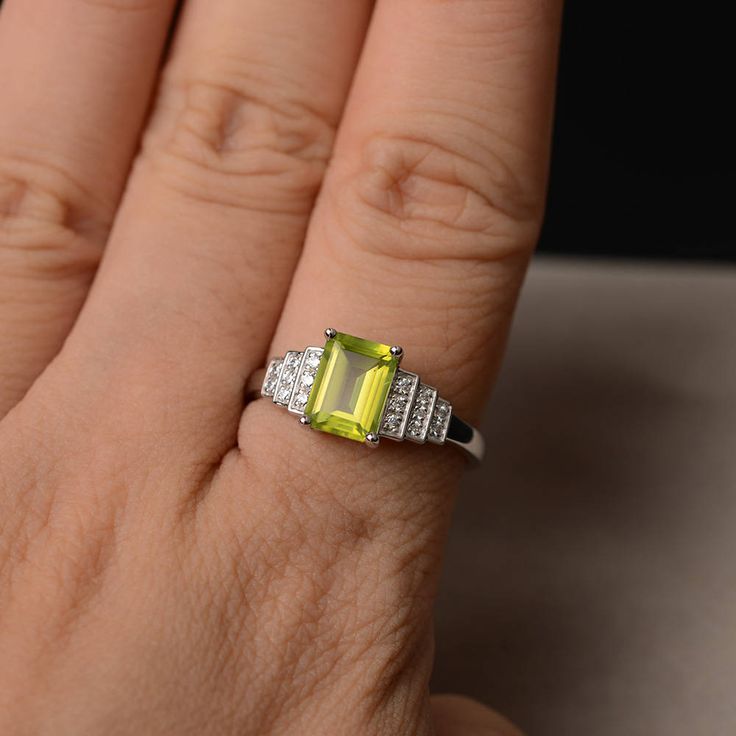 This is a gorgeous handmade creation. Its beauty is its simplicity & Elegance. The 6*8mm emerald shape faceted natural peridot is crafted in solid sterling silver and with rhodium plated. All item is sent in a beautiful gift box If you have any idea of design your ring,pls contact me directly. You can realize more lovely stuff clicking the link https://www.etsy.com/shop/knightjewelry?refshopsection_shophome_leftnav Please leave the correct address and you phone number for delivering successf Emerald Cut Peridot Ring For May Birthstone, Emerald Cut Peridot Gemstone Jewelry, Green Citrine Rings With Accent Stones, Green Citrine Gemstone Rings, Green Emerald Cut Crystal Birthstone Ring, Emerald Cut Peridot Birthstone Ring, Emerald Cut Green Crystal Birthstone Ring, Emerald Cut Peridot Ring Gift, Lime Green Gemstone Birthstone Ring As Gift