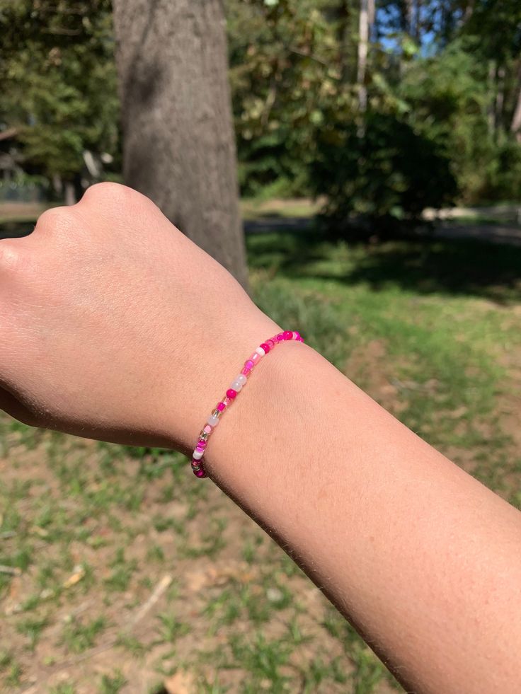 The Pretty in Pink Bracelet would make a perfect gift for a loved one or friend! Featuring clay beads in the colors of different shades of pink, as well as white and gold. * Handmade in Texas - and made to order! * Bracelet length: 6.75" (standard) Materials: Clay disc beads * Please measure your wrist before ordering as we do not offer returns or exchanges for resizing * You may request custom sizes in the personalization box. We can also make bracelets for children as well, but please measure their wrists for the most accurate fit. *These bracelets make great gifts for all occasions and are perfect for stacking or wearing alone! * All sales are final and no refunds will be issued. *Keep bracelet away from small children due to choking hazard *Keep bracelet dry and away from water and che Pink Hand-strung Heishi Beads Friendship Bracelets, Pink Heishi Beaded Bracelets With Colorful Beads, Pink Heishi Beads Bracelets With Colorful Beads, Pink Heishi Beads Bracelet With Colorful Beads, Pink Heishi Beads Colorful Beaded Bracelets, Pink Heishi Beads Bracelet, Pink Heishi Beads Bracelet For Gift, Pink Heishi Beads Bracelets As Gift, Pink Heishi Beaded Bracelets With Letter Beads