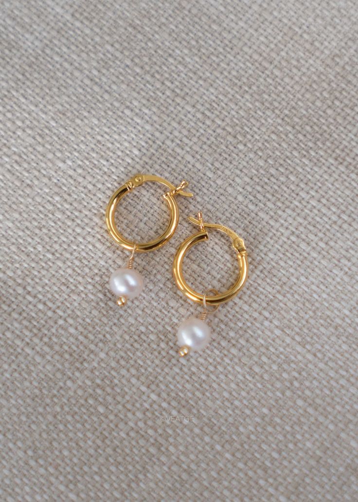 Our Pearl Hoop Gold Earrings in 18k gold vermeil are an all time classic hoops that pairs well with every outfit and suits everyone. Sold as a pair. DETAILS * Dimension -  Gold Hoops - 13mm, total length - 25mm * Materials - 18k gold thick gold vermeil over 925 sterling silver (nickel free, hypoallergenic), genuine freshwater round pearl * Handmade in our sunny Houston jewelry studio SHIPPING * At checkout, you also have the option to choose faster shipping on the drop-down menu. We highly recommend upgrading to Priority Shipping with Signature Confirmation at our discounted price; it is better, faster & secure compared to free standard shipping. Simply add this listing to your existing order https://www.etsy.com/listing/802692983/usps-priority-shipping-upgrade. * Additional shipping upgra Gold Huggie Pearl Earrings For Anniversary, Everyday Gold Huggie Pearl Earrings, Gold Plated Hoop Earrings With Pearl Drop As Gift, Classic Dangle Huggie Earrings In 14k Gold Filled, Gold Small Hoop Pearl Earrings For Everyday, Gold 14k Gold Filled Huggie Earrings With Pearl Drop, Gold Huggie Pearl Earrings For Gift, Gold Huggie Pearl Earrings As Gift, Gold Huggie Earrings With Pearl Charm As Gift