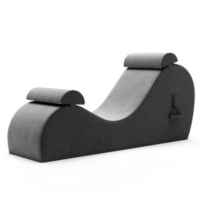 a black and white photo of a modern lounge chair with grey fabric on the back