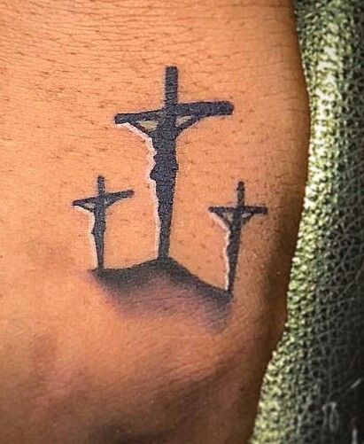 a tattoo with three crosses on it