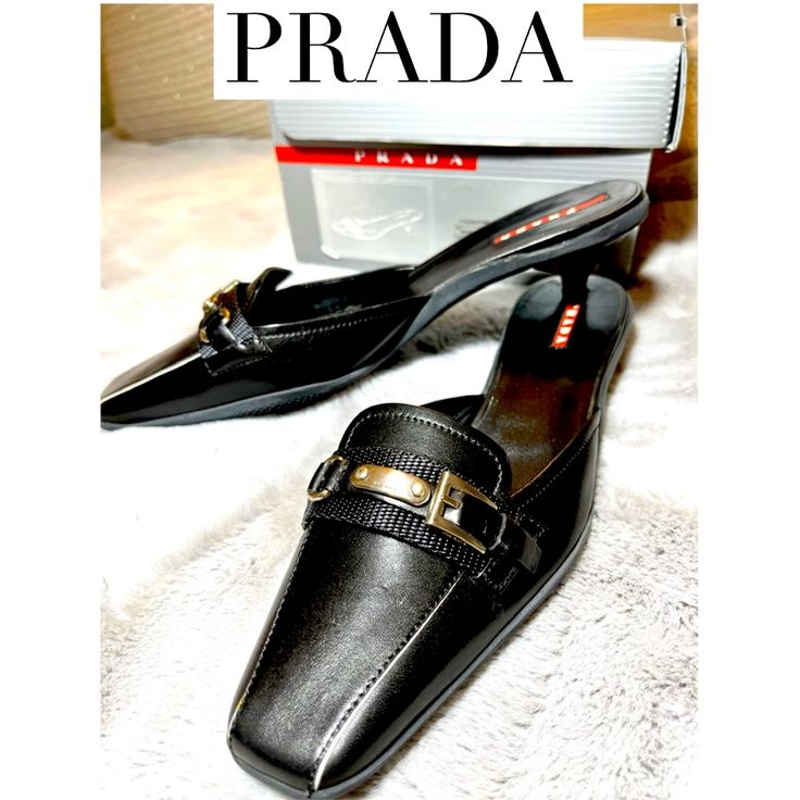 Prada Black Leather Mules, Kitten Heels -New With Tag, Never Worn -Purchased From Saks 5th Ave Circa 2007 -Rubber Sole -Group Name: Sport Profilia -“Calzature Donna” -Size 37 Women -Slight Dent On Left Shoe From Storage, Barely Noticeable. Shown In Photo With My Finger Pointing To It. Elegant Closed Toe Clogs With Buckle Closure, Formal Black Clogs With Padded Heel, Black Formal Clogs With Padded Heel, Formal Pointed Toe Clogs With Padded Heel, Black High Heel Clogs For Formal Occasions, Elegant Low Heel Workwear Clogs, Black Clogs For Formal Spring Occasions, Black Formal Clogs For Spring, Elegant Office Slip-on Clogs