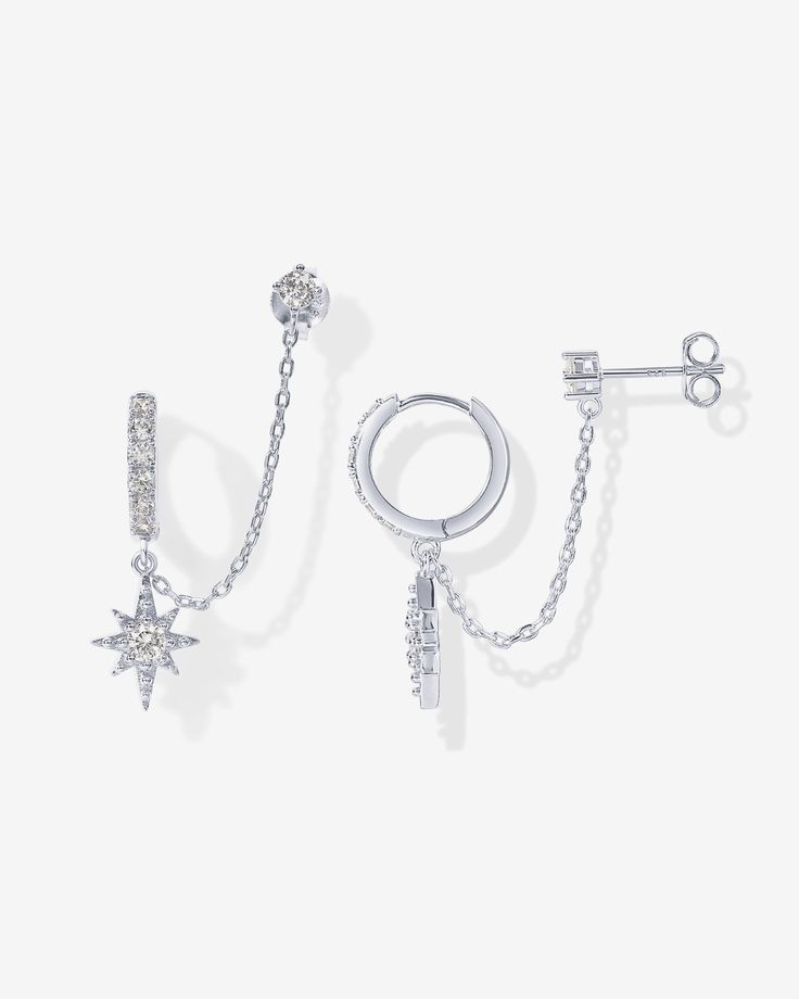 These chained star dangle huggie x premium AAAAA cubic zirconia stud feature an 8mm in diameter CZ huggie, an 11.5mm x 9mm dangling star charm, 3mm CZ Stud Earring, and a 30mm long connecting chain - suitable for women with two or more piercings. Materials 14K yellow gold or white gold plated. s925 Sterling Silver Posts. AAAAA Premium Cubic Zirconia. Measurements: Outer Huggie Diameter: 13mm; Chain Length: 30mm. Star Pendant: 11.5x9mm; Stud: 4.3mm x 2.2mm. Stone sizes: star pendant stone: 3.2mm; White Gold Jewelry With Star Charm Dangle, Cubic Zirconia Star Charm Dangle Jewelry, Cubic Zirconia Dangle Jewelry With Star Charm, Diamond Earrings For Women, Gold Chain Earrings, Double Piercing, Mini Earrings, Ear Cuff Earings, Star Earrings Stud