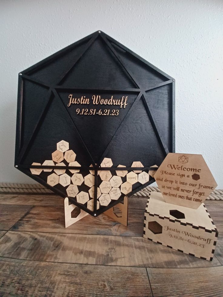 a black and gold wedding gift with wooden cutouts on the front, an umbrella shaped like a hexagon