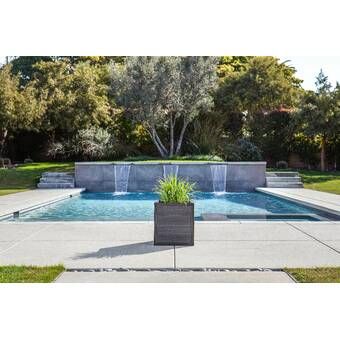 a pool with a fountain in the middle of it