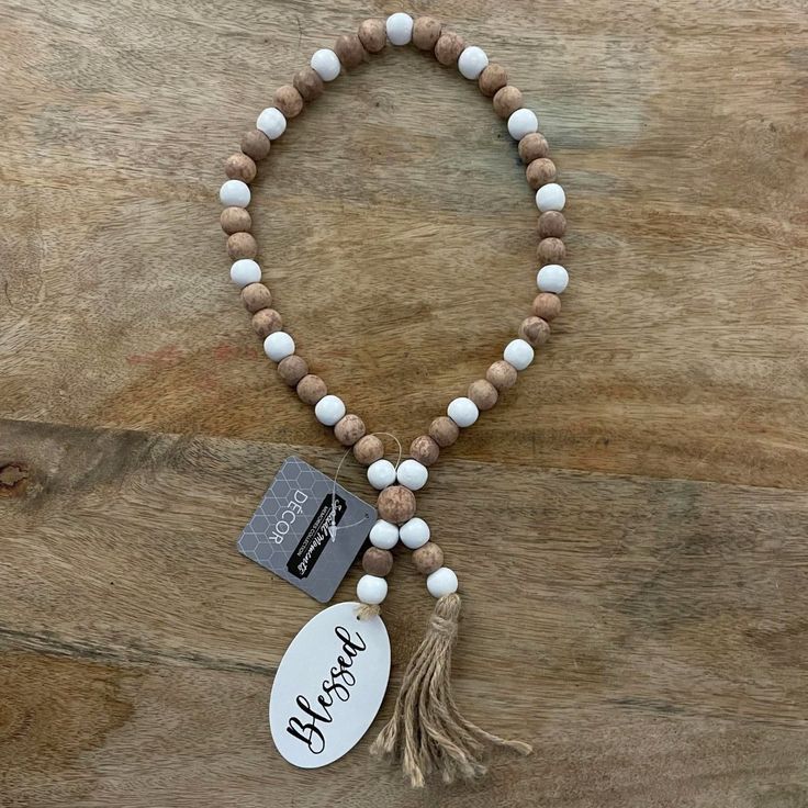 a wooden beaded bracelet with a tag and tassel