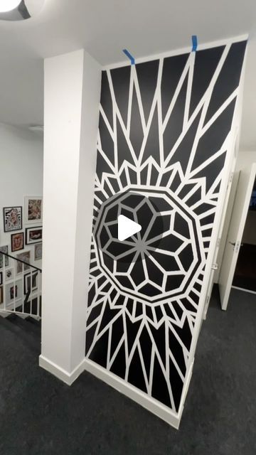 a room divider with an intricate design on the front and back wall, along with several framed pictures