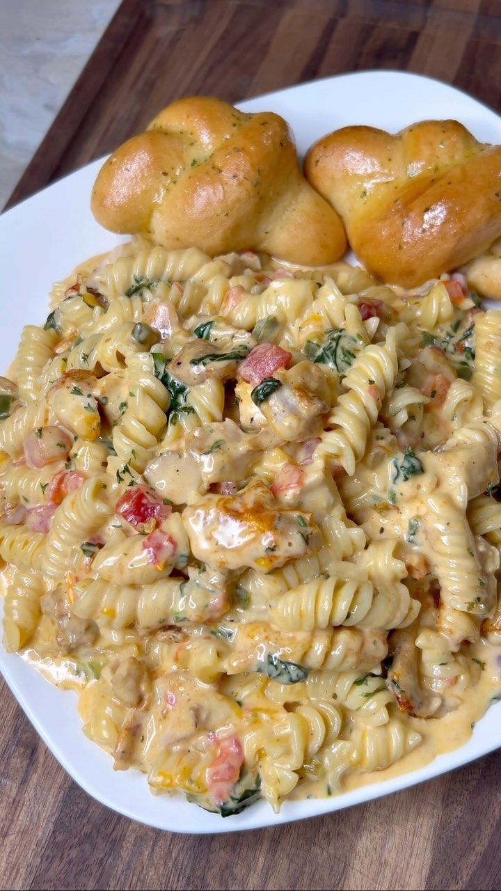 some rolls and pasta on a white plate