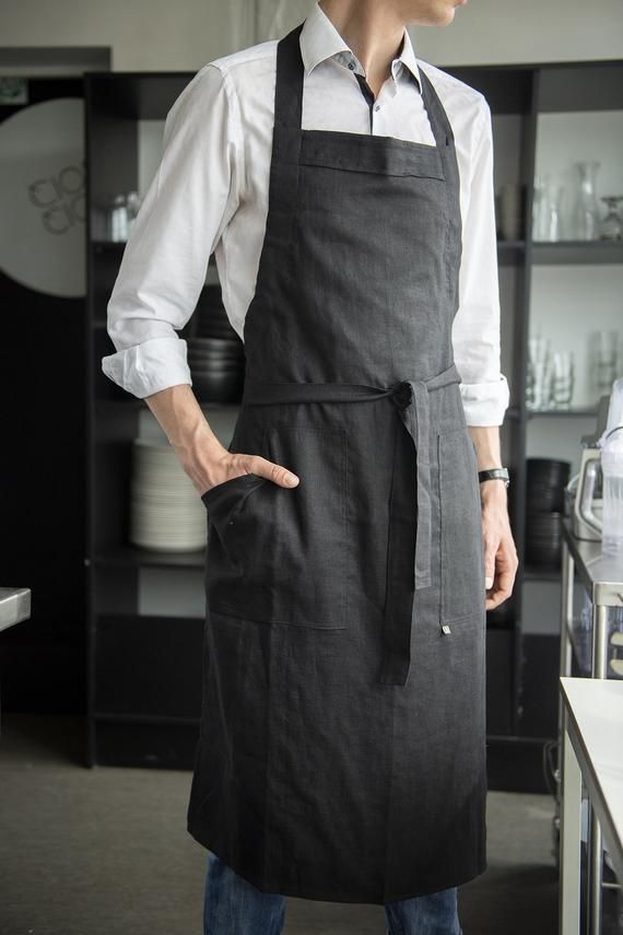 Stylish, adjustable length linen apron for man. Natural and comfortable men's aprons are made with large comfy pockets + loop for easy hanging. Great for daily use. Perfect as a gift!* length: 44" / 112 cm* width: 26" / 66 cmModel, Lukas is 75" / 190cm tall, wears black linen apron* find more aprons and kitchen linens here:https://www.etsy.com/shop/LovelyHomeIdea?section_id=18945683* safe Oeko-TEX® Standard 100 certified linen fabric.* designed and carefully handmade by Lovely Home Idea in small Apron Outfit Men, Apron For Cooking, Man In Apron Drawing, Waiter Outfit Men, Cooking Aprons For Men, Chef Outfit Men, Men Aprons Ideas, Barista Outfit Men, Guy In Apron