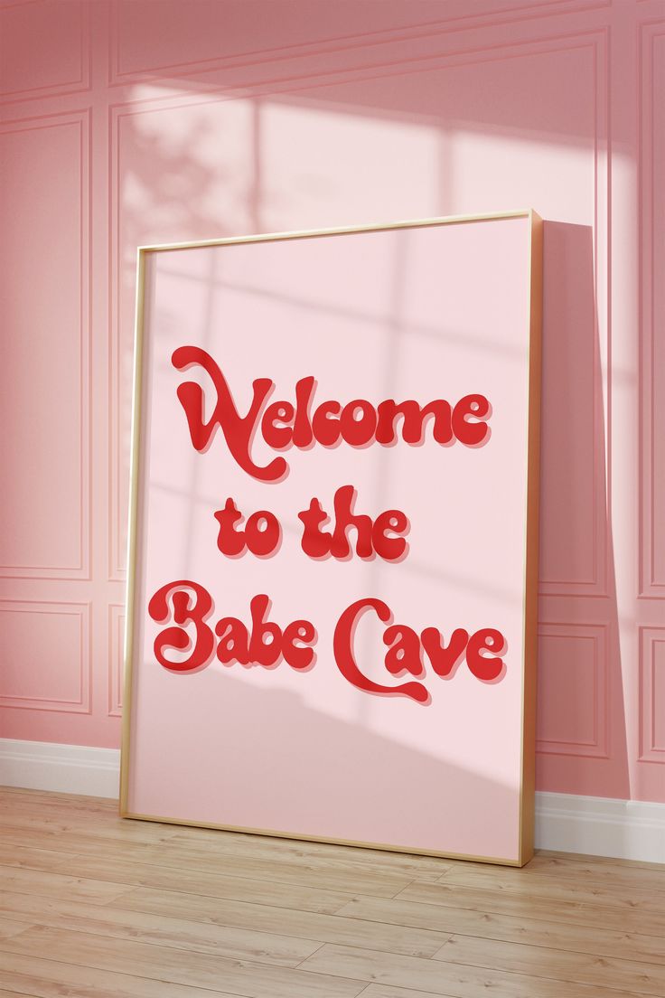 a sign that says welcome to the babe cave in red lettering on a pink wall