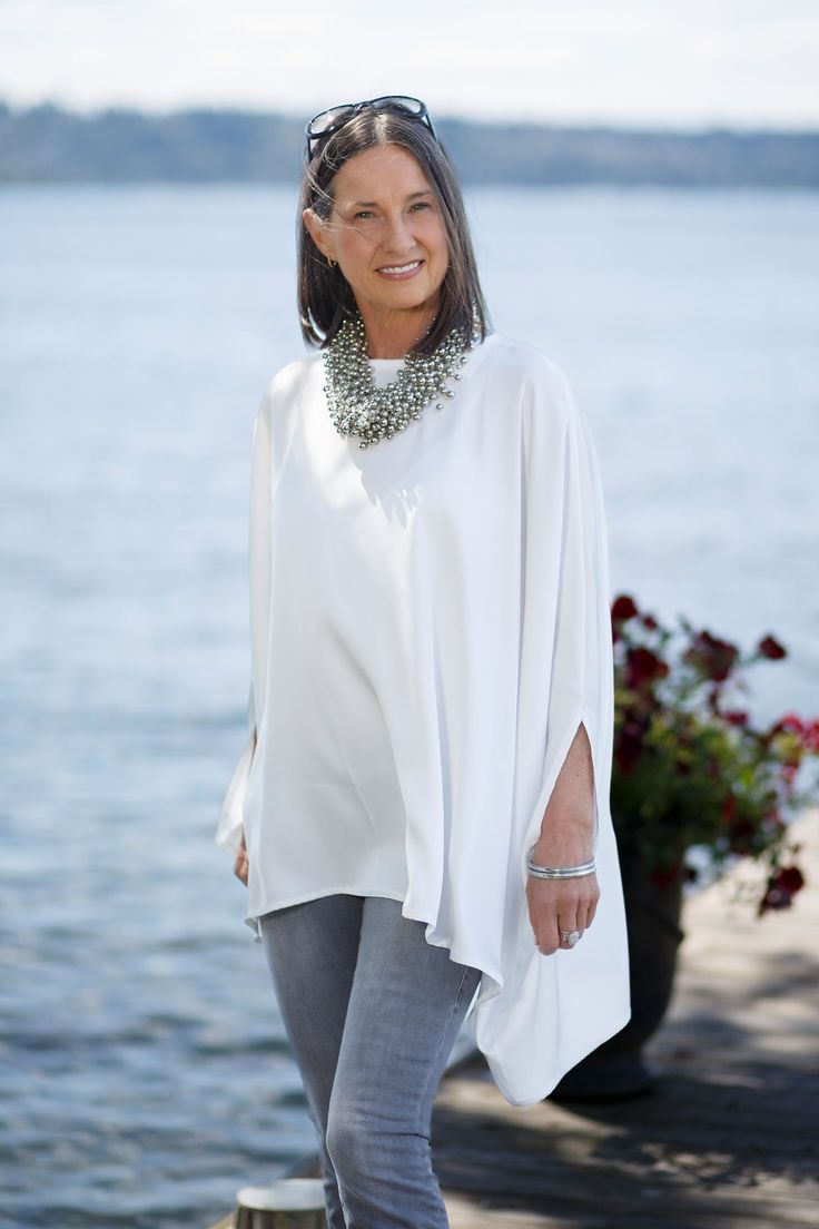 This gorgeous new addition to our Calabria Collection is perfect for a night on the town or dressed down with jeans running errands. Either way you’ll look elegant with classic style. This flowy top is crafted from lightweight viscose fabric for a look that's distinguished yet comfortable. This poncho comes in one size and is 100% viscose. Cheap White Winter Poncho, Luxury White Tunic, Luxury Women's Poncho With Scarf, Luxury Tunic Kimono For Women, Luxury Casual Poncho For Women, Luxury Oversized Chic Poncho, Luxury Flowy Tunic For Women, Luxury Chic Poncho With Batwing Sleeves, Luxury Oversized Poncho For Spring