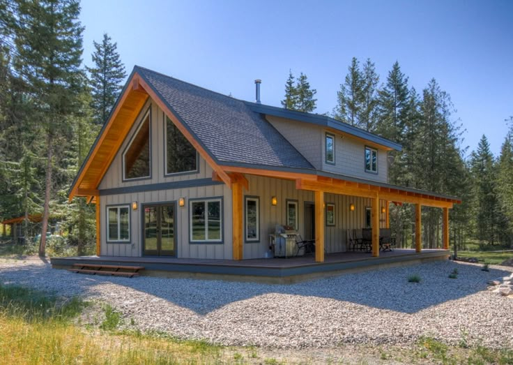 a house in the middle of a field surrounded by trees