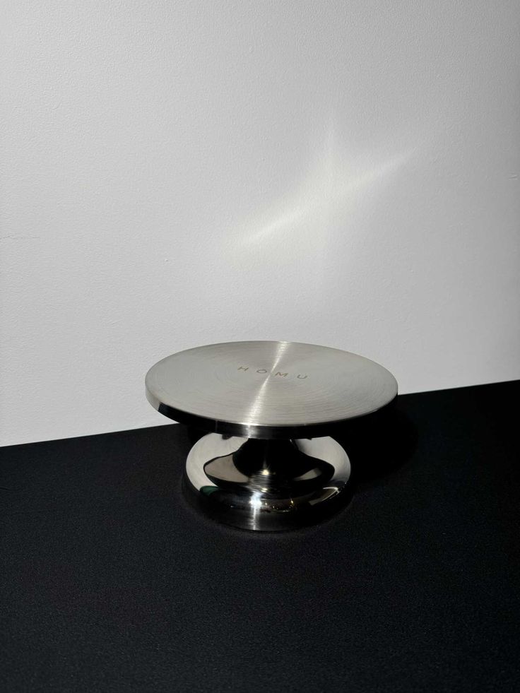 a black table with a silver plate on it