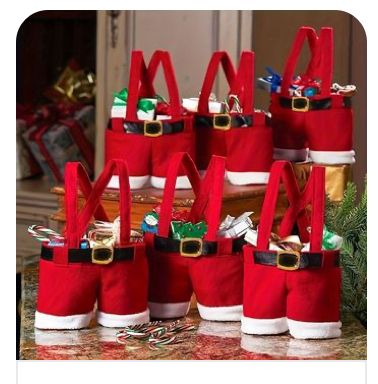 a group of red bags sitting on top of a counter covered in santa claus's