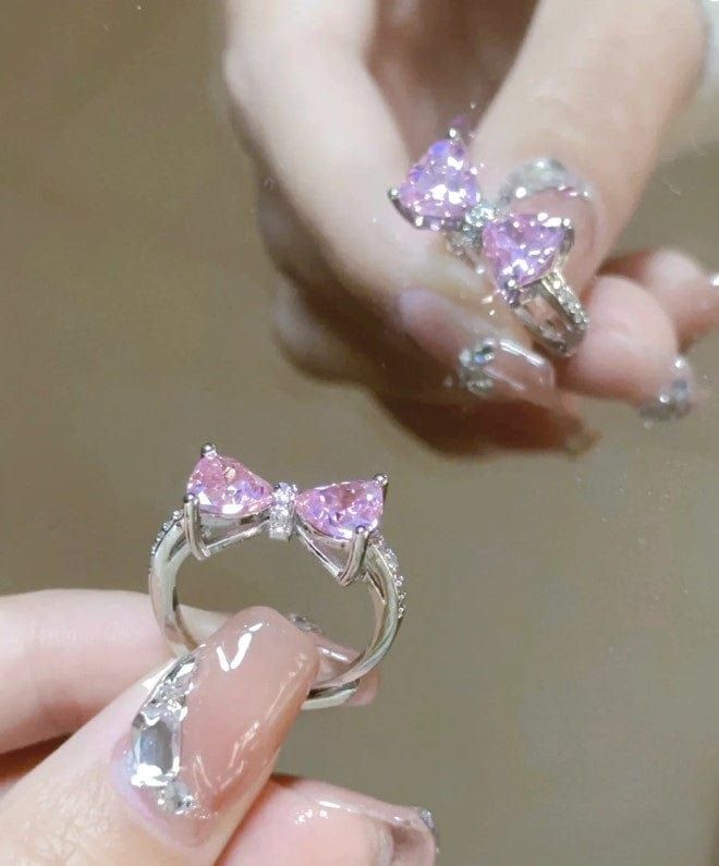 Sweet Colorful Crystal Heart Bowknot Ring Add a pop of sweetness to any outfit with our Sweet Colorful Crystal Heart Bowknot Ring. The colorful crystals and adorable bowknot design make this ring a must-have accessory for any cute and charming look. Show off your style with this lovely and lovable ring. Pink And Purple Engagement Ring, Purple Kawaii Nails, Kawaii Wedding, Heart Clutch, Colorful Crystals, Pink Diamond Ring, Pretty Jewelry Necklaces, Bow Ring, Kawaii Style