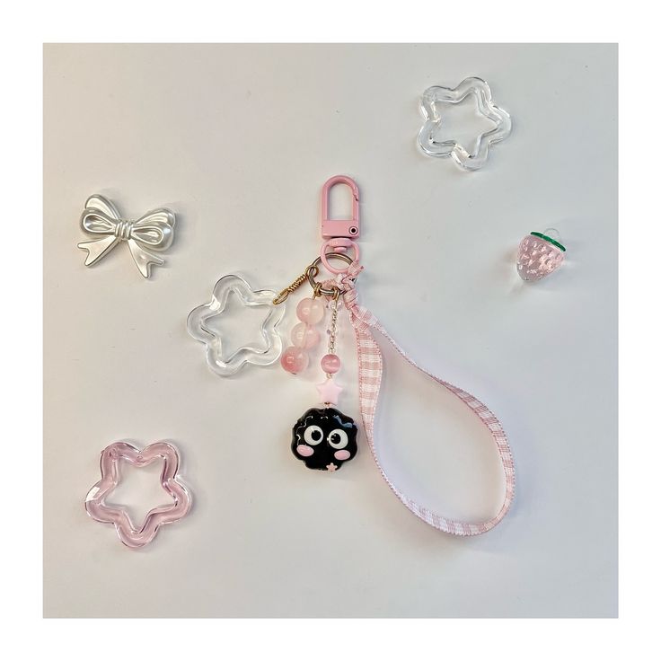 the keychain is decorated with different shapes and sizes, including an animal shaped pacifier