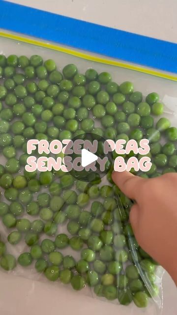 a bag filled with green peas sitting on top of a white table next to a person