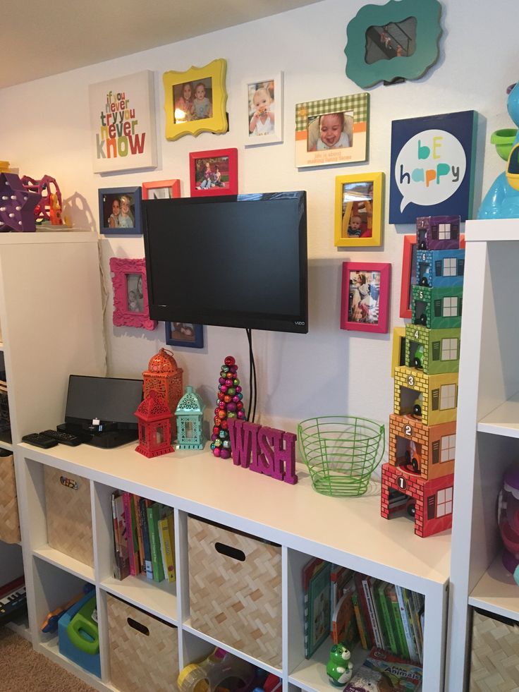 there is a flat screen tv on top of the bookshelves