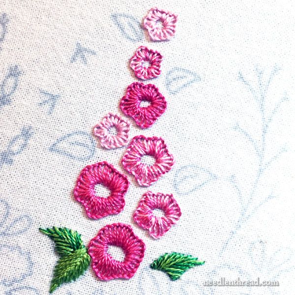 pink and green flowers on white fabric