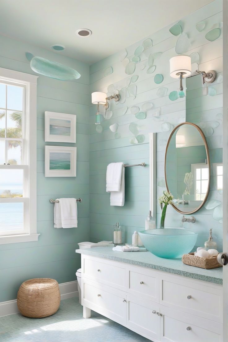 a bathroom with blue walls and white fixtures, including a round mirror above the sink