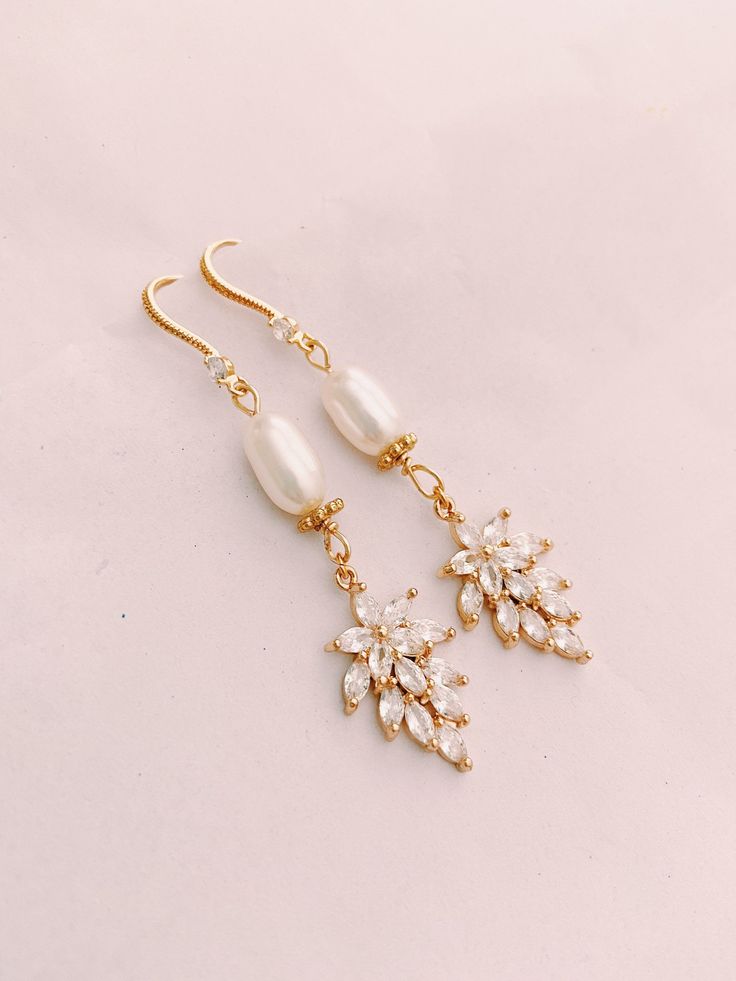 ITEM FAQ: - Length: 6.3cm - Material: Real Gold plated Brass, 18k Gold plated Earrings Hooks, Genuine Freshwater Pearl - Features: Lightweight, Unique and Simple design - Handmade. Ready to ship within 1~2 business days I personally source and assemble all my Jewelry Pieces with love in California ♡ Usually processing time is same day.... I work on my business everyday :) Choose the USPS shipping time best fit for you. These gold earrings are genuine Gold plated. Each item is manufactured to the Elegant Marquise Single Earring, Elegant Marquise Gold Bridal Earrings, Elegant Gold Marquise Bridal Earrings, Dainty Marquise Earrings As Gift, Gold Plated Dangle Plug Earrings For Wedding, Single Marquise Earring For Anniversary, Dainty Marquise Wedding Earrings, Elegant Marquise Bridal Earrings For Pierced Ears, Elegant Yellow Gold Crystal Earrings With Ear Wire