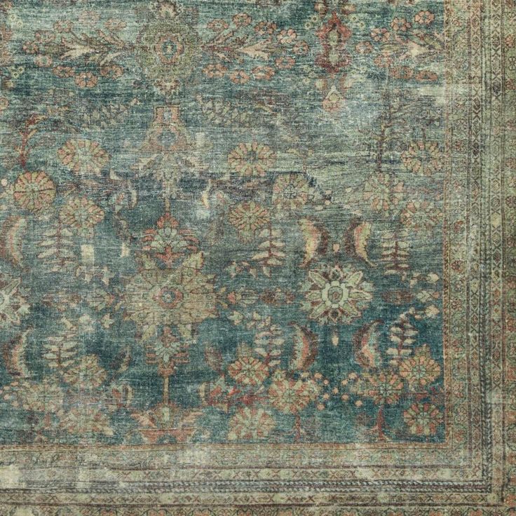 an antique rug with many different colors and patterns