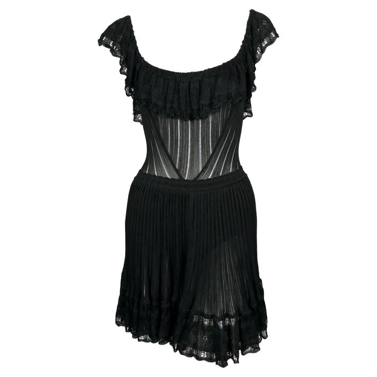 Very rare, jet-black semi-sheer dress with flounced pointelle trim and bustle back designed by Azzedine Alaia dating to the summer of 1992 exactly as seen on the runway. Dress is cleverly designed so that the flounce covers the bust along with built in shorts for modesty. Labeled a size S. Approximate measurements (unstretched): bust 28", waist 22" and overall length 34". Fabric content: 86% rayon, 5% other fibers, 6% nylon and 3% spandex. Zips up center back. Made in Italy. Very good condition. Azzedine Alaia Hooded Dress, Sheer Dress Outfit, 90s Dolce And Gabbana, Lace Runway, Lace Sheer Dress, Todd Haynes, Alaia Dress, Azzedine Alaïa, Mongolian Lamb