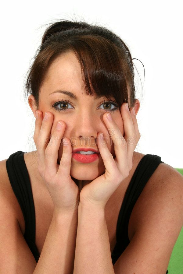 a woman is posing with her hands on her face and looking at the camera while wearing black