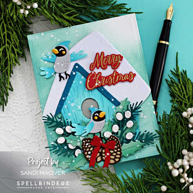 a close up of a christmas card on a table with pine branches and other decorations