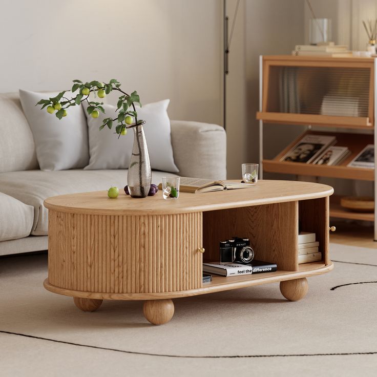 a living room with a couch, coffee table and bookshelf on the floor