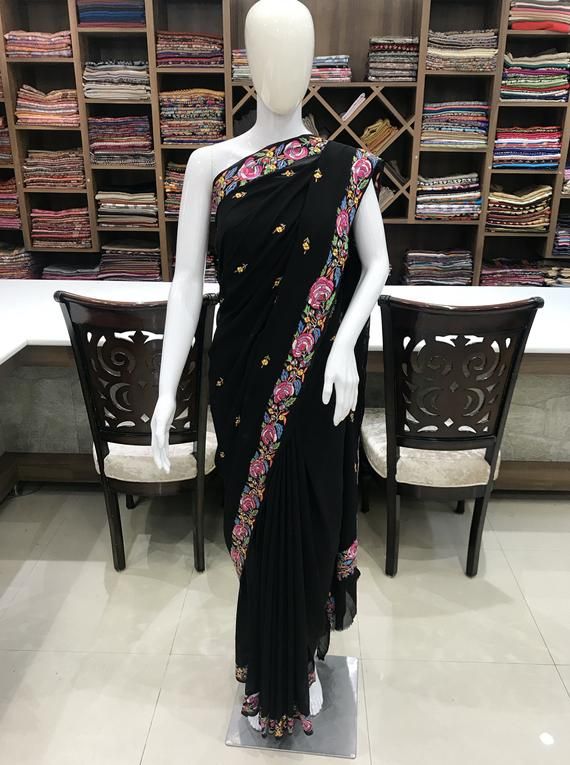 A Marvellous Embroidered Kashmiri Saree which you can wear at any party or a wedding.- - - - - - - - - - - - - - - - - - - - Product Details- Condition: Brand New- Product: Kashmiri Saree - Embroidery: Multi-Colour Papier Mache Hand Embroidery.- Colour: BlackF A B R I CSaree: Viscose GeorgetteBlouse: Indian CrepeF I N I S H- UnstitchedYou can get it stitched locally.- StitchedWant your blouse ready to wear, let us know the style you want and we will stitch it for you.***PLEASE NOTE: We would req Semi-stitched Embroidered Georgette Dress, Fitted Party Blouse With Embroidered Border, Navratri Georgette Dress With Embroidered Border, Georgette Dresses With Embroidered Border For Navratri, Fitted Embroidered Dress With Zari Work For Diwali, Fitted Traditional Wear With Embroidered Border For Party, Fitted Bollywood Dress With Embroidered Border, Semi-stitched Georgette Dress With Embroidered Border, Navratri Anarkali Dress With Embroidered Border