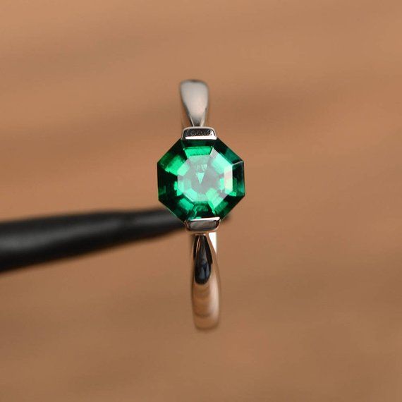 It is a lab emerald ring. The main stone is 7 mm*7 mm octagon cut.weight about 1.25  caratsThe basic metal is sterling silver and plated with rhodium.To change the metal to a solid gold (white/rose) or platinum is also available, please ask for a quotation if you want.You can also go to my shop Home for more elegant rings: https://www.etsy.com/shop/godjewelry?ref=hdr_shop_menu Emerald is May birthstone More emerald rings:https://www.etsy.com/shop/godjewelry?ref=seller-platform-mcnav&section_ Green Octagon Emerald Ring With Bezel Setting, Emerald Octagon Ring With Diamond Cut, Octagon Birthstone Ring For Promise, Green Octagon Birthstone Jewelry, Sterling Silver Asscher Cut Emerald Promise Ring, Green Octagon Emerald Ring With Diamond Cut, Faceted Emerald Promise Ring, Green Emerald-cut Birthstone Ring With Bezel Setting, Octagon White Gold Emerald Ring