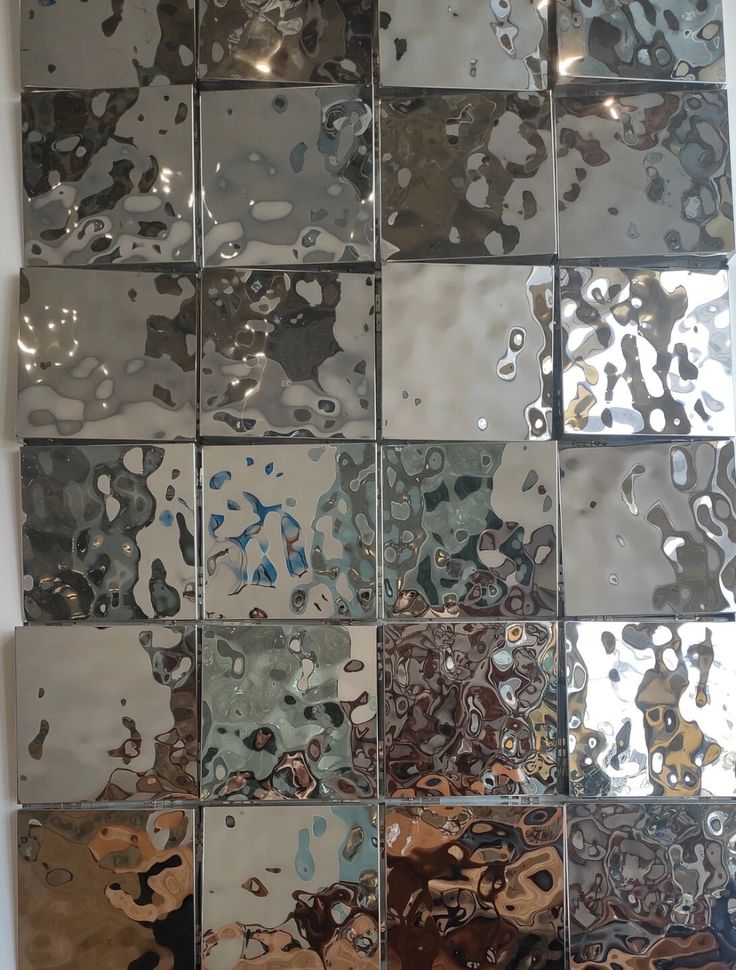 several different types of glass tiles are arranged in the same pattern as they appear on the wall