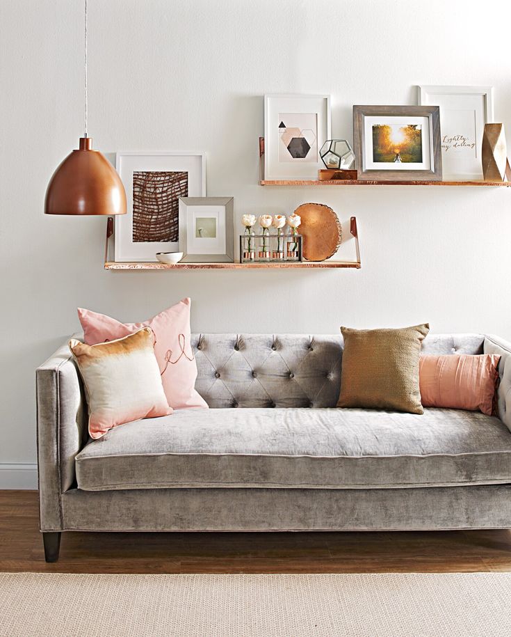 a couch with pillows and pictures on the wall above it that says pinterest