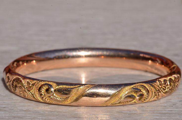 Art Nouveau Bracelet, W.M.C., Wolcott Manufacturing Bangle.  This gold filled bangle measures 8.4mm in width and is signed WMC.  The bangle fits up to a 6.75 inch wrist and features fine piercing and engraving throughout.   Love this piece, but don't have the money to spend right now?  We offer FREE layaway on every item in our shop.  With just 20% down, take one full year (interest-free) to pay off your new jewelry!  There are no hidden fees or charges, ever.  For more information on our layawa Heirloom Style Polished Gold Bangle, Classic Gold Bangle Bracelet With Intricate Design, Classic Gold Bangle With Intricate Design, Heirloom Bangle Bracelet With Polished Finish, Classic Bracelets With Decorative Band As Gift, Gold Bracelet With Decorative Band For Anniversary, Heirloom Bangle Bracelets For Anniversary, Yellow Gold Bangle Bracelet With Decorative Band, Yellow Gold Bangle With Decorative Band