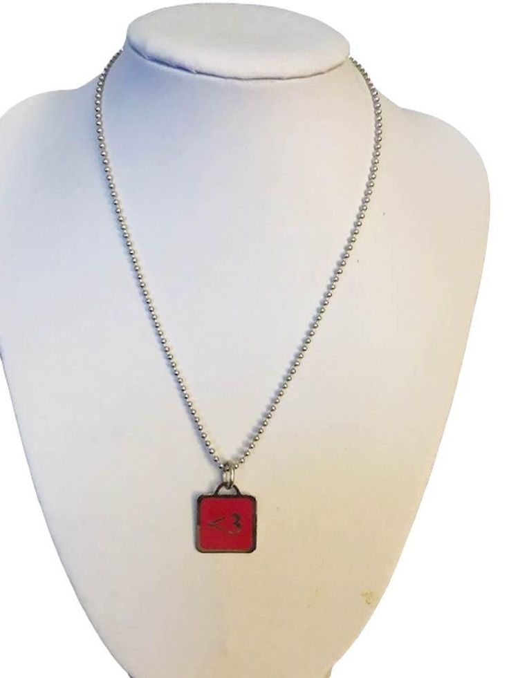 Wear you heart on your sleeve....or anywhere you want! The Heart pendant is a perfect accessory for anyone who loves love. Heart emoticon pendant in brass/red enamel with a silver tone non-tarnish coating. Pendant measures 5/8 x 5/8 inches. The pendant hangs on a modern silver tone 2mm beads chain measuring 16 inches in length. Pendant and "heart" description card are packaged in a bright green pouch. Heart Emoticon, 2mm Beads, Heart On Your Sleeve, Black Onyx Necklace, Beads Chain, Onyx Necklace, Red Sneakers, Childrens Jewelry, Sneakers Men Fashion