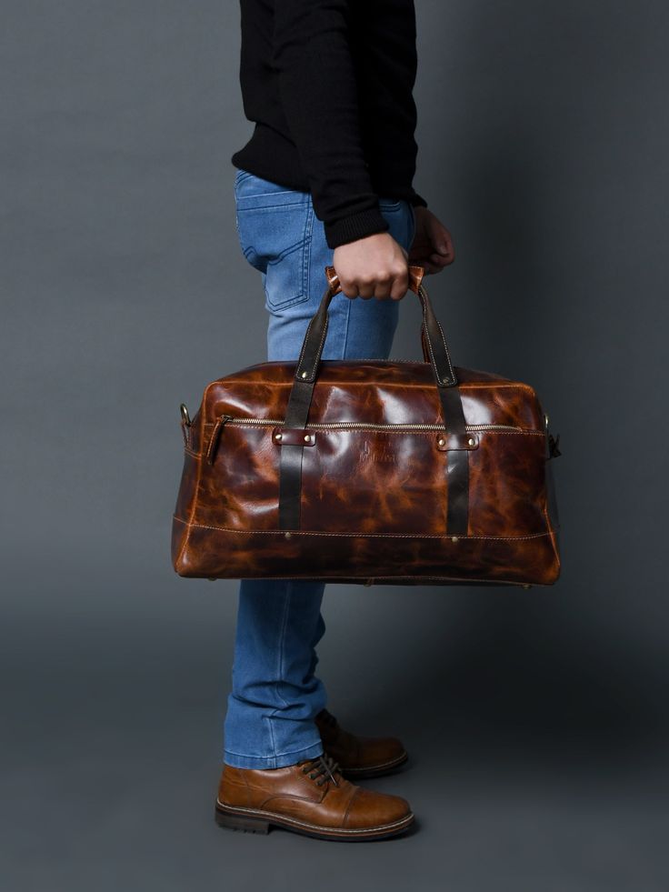 Here is the perfect blend of sophistication and style with our unique leather duffle bag in a rich, textured saddle tan, accented by sleek black handles. The full-grain buffalo leather adds to the endurance yes well as the charm of the duffle bag. Best for short trips and routine journeys. Elevate your travel game with this distinctive accessory today! Salient Features Made of full-grain premium buffalo leather Pure brass hardware with bottom studs to protect the bag Adjustable leather shoulder Leather Duffle Bag With Leather Trim For Business, Everyday Saddle Satchel With Leather Handles, Everyday Leather Duffle Bag, Brown Leather Trim Duffle Bag For Business, Brown Leather Trim Weekender Bag For Business, Business Brown Duffle Bag With Leather Trim, Daily Use Leather-lined Satchel Duffle Bag, Brown Business Duffle Bag With Leather Trim, Cognac Saddle Satchel With Leather Handles