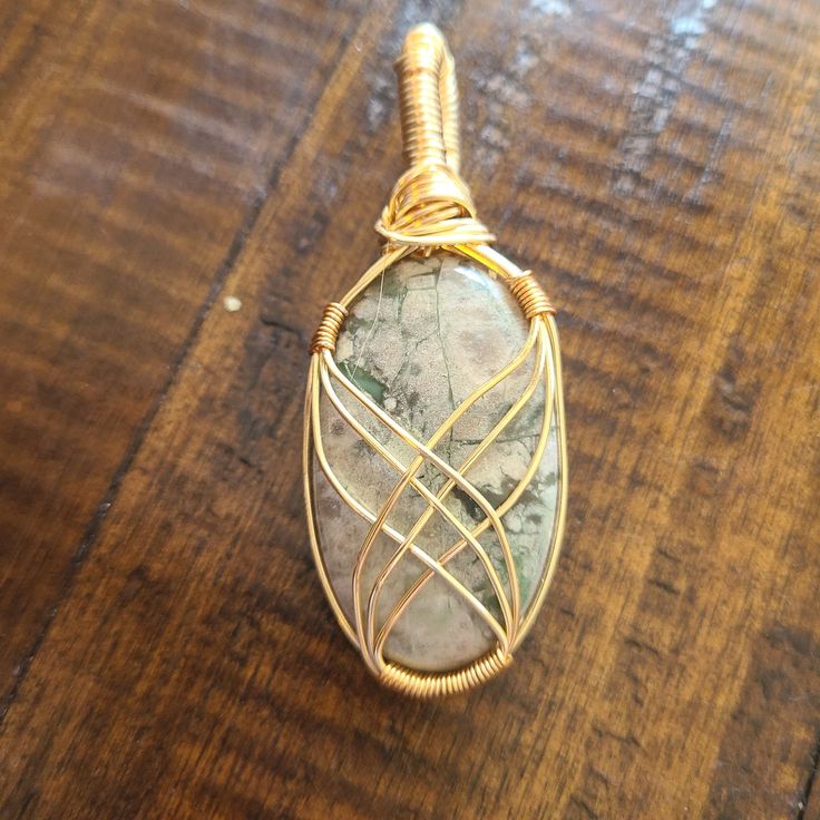 This cabochon is wrapped in tarnish resistant wire. You can choose between just the pendant or a pendant with a chain. The chain will be the same color as the wire (stainless steel, 18k plated gold, 18k, plated rose gold). Gold Moss Agate Pendant Jewelry, Wire Pendant Necklace As A Gift, Wire Pendant Necklace For Gift, Copper Wire Teardrop Pendant Jewelry Gift, Copper Wire Teardrop Pendant Jewelry For Gift, Bronze Wire-wrapped Round Pendant Jewelry, Bronze Wire Wrapped Round Pendant Jewelry, Oval Gold Wire Wrapped Necklaces, Gold Oval Wire Wrapped Necklace