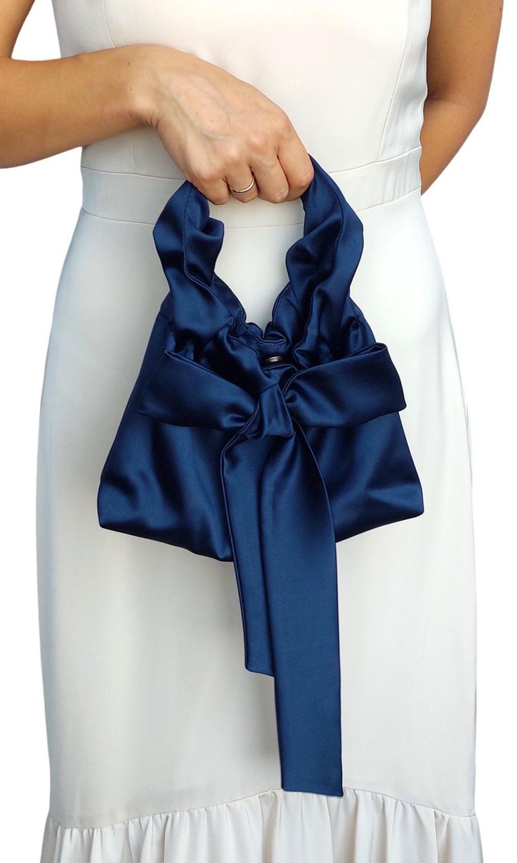 Navy navy blue bag knot satin bag purse, wedding bow bag, party nandbag, elegant clutch,Handmade bag for event party, Satin Evening Bag Gift I invite you to check out this charming handbag for women, which is made of exquisite satin (satin) and is designed to emphasize your unique beauty and elegance.  This handbag is ideal for those who value quality and style.  Features:  * Material: satin (satin)  * Fastener: metal button fastener  * Dimensions: width 23 cm / 9 inches, height 18 cm / 7 inches Chic Party Bag With Ribbon Detail, Chic Party Bag With Ribbon, Elegant Party Bag With Satin Bow, Elegant Evening Bag With Satin Bow, Elegant Evening Bags With Satin Bow, Elegant Formal Bag With Satin Bow, Elegant Satin Clutch Bag, Elegant Party Bags With Satin Bow, Elegant Bag With Ribbon For Gift