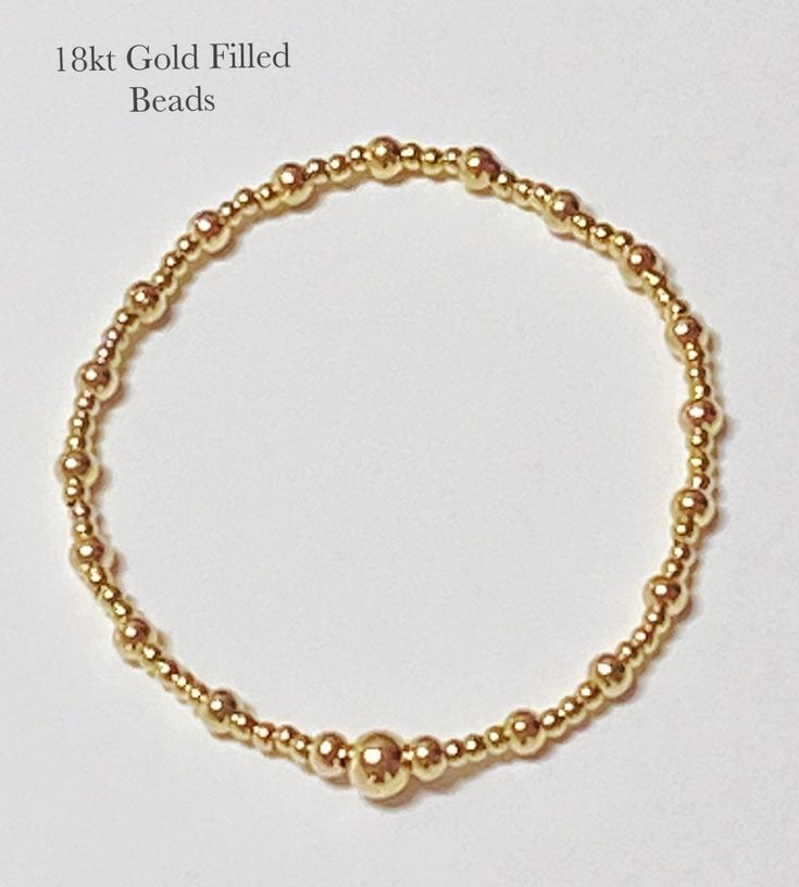 "2 & 4 mm gold filled beads are used to make this beautiful bracelet Your jewelry is made by us specifically for you. Lots of love and care is strung into each bead every piece is very special to us each piece is hand made at the time it's ordered. If there's anything you would like to customize please let us know we're happy to accommodate you. All our products are handmade and we take great pride in our work .. Every piece is like one of my children. When shopping for quality long lasting hand Classic Gold Beaded Bracelets In 14k Gold Filled, Classic 14k Gold Filled Bracelets With Gold Beads, Classic 14k Gold-filled Bracelets With Gold Beads, Classic Gold Beaded Bracelets With Tiny Beads, Hand-strung Gold Bracelet With Round Beads, Gold Stretch Bracelet With 14k Gold-filled Beads, Gold Beaded Bracelets With Polished 14k Gold, Classic Gold Beaded Bracelet With Tiny Beads, Hand-strung Gold Round Bead Jewelry