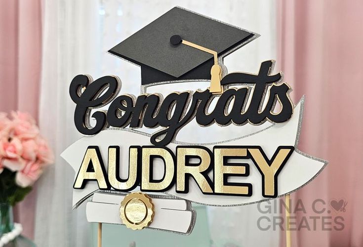 a graduation cake topper with the words congrats and a graduate's cap on it