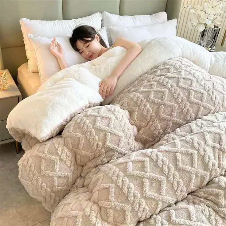 a woman is laying in bed with pillows